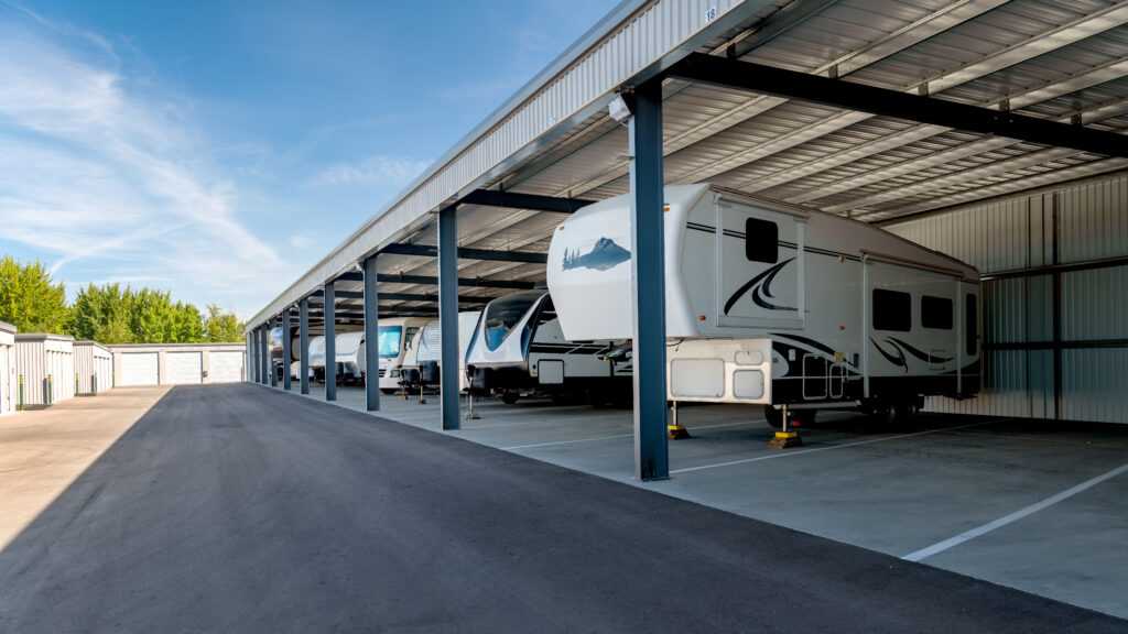 Covered RV storage area with multiple recreational vehicles parked in a spacious facility